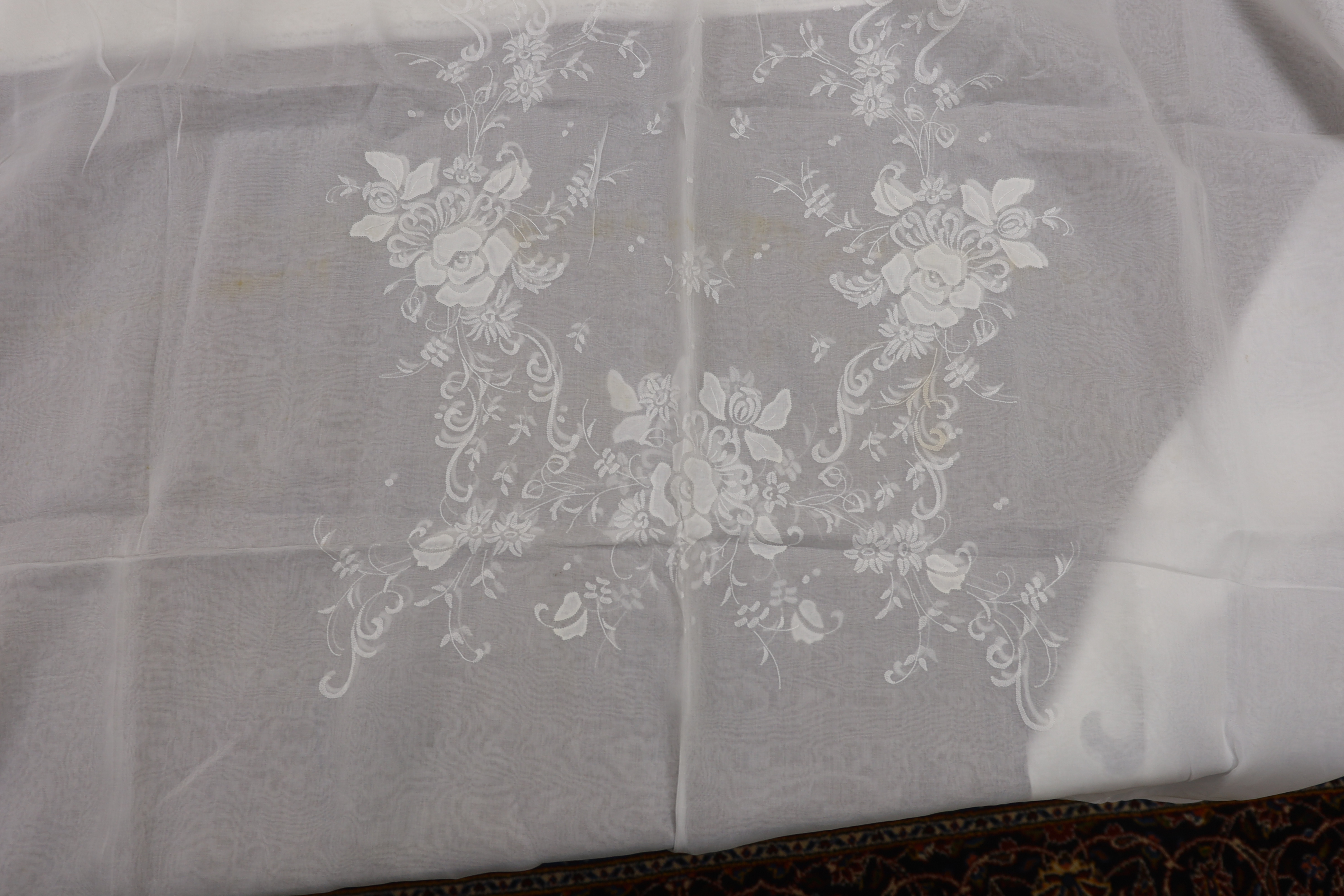 Table linen; A large linen embroidered and finely worked table cloth, an Anglaise worked cloth with crochet border and a fine appliqué cloth (3)